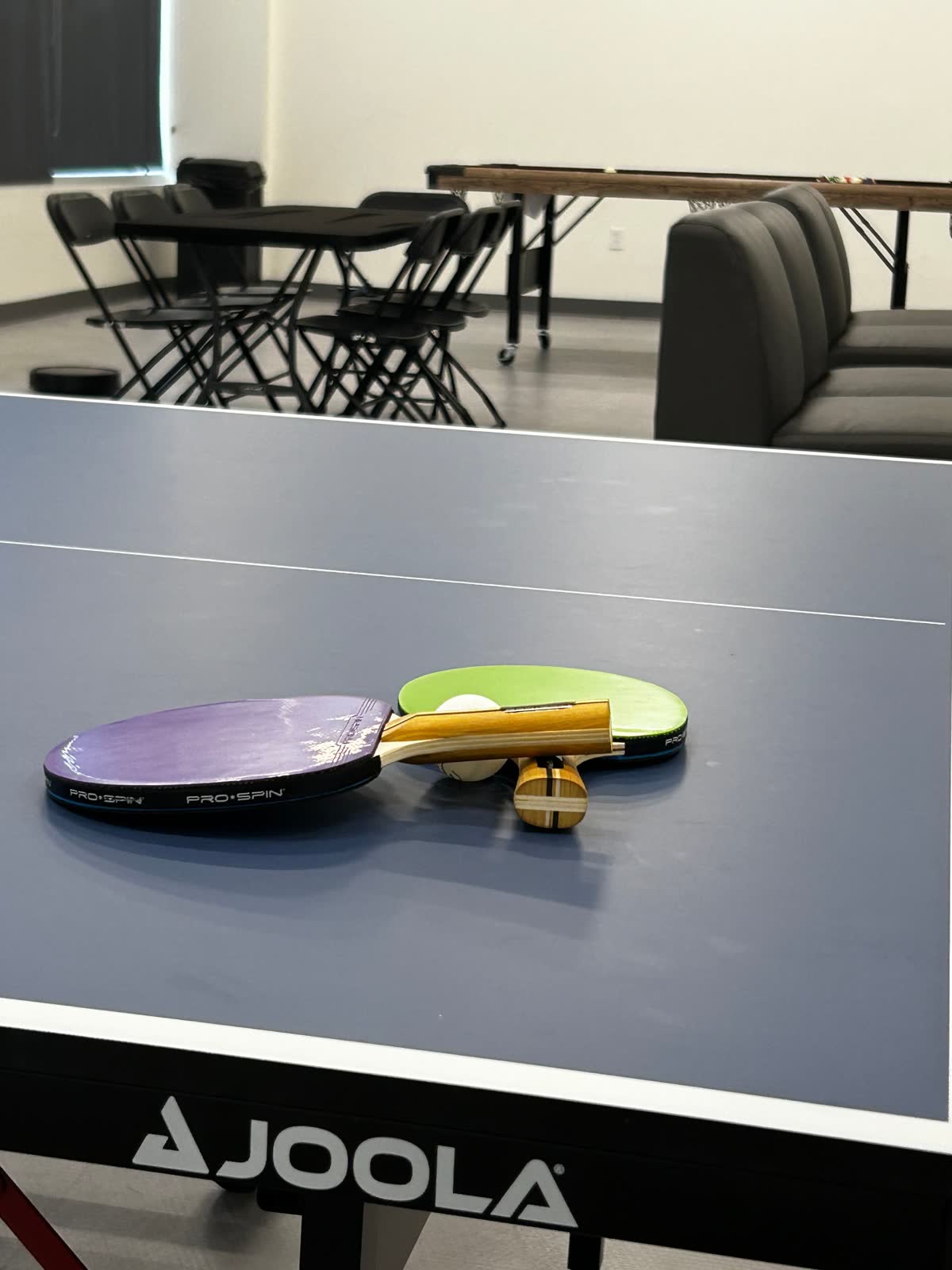 Ping pong table with paddles and ball at the Teen Lounge inside The Link in Nocatee